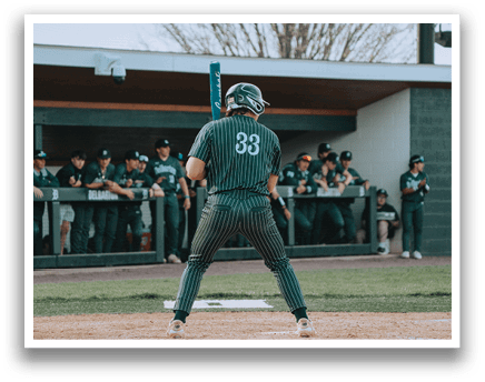 A baseball player holding a bat. Description generated by AI