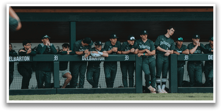 A baseball player wearing a green jersey with the number 7 on it. Description generated by AI