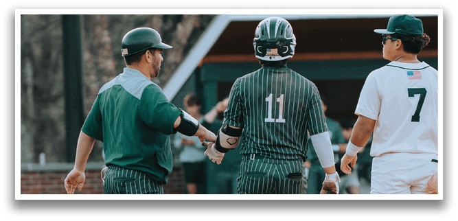 A baseball player wearing a green and white uniform. Description generated by AI