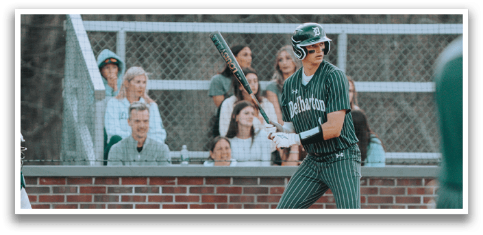 A baseball player is swinging a bat on a field. Description generated by AI