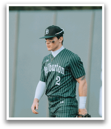 A baseball player wearing a green and white uniform. Description generated by AI