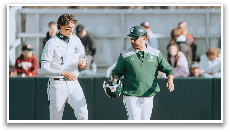 Two men wearing white uniforms are talking to each other. Description generated by AI