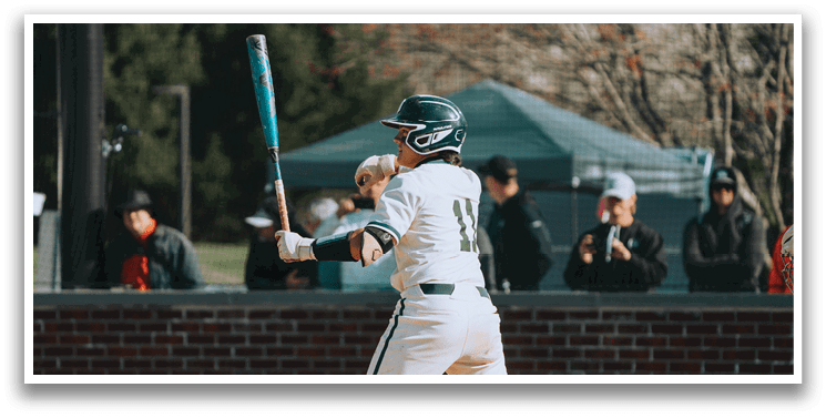 A baseball player in a white uniform is pitching a ball. Description generated by AI