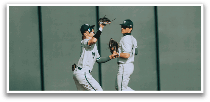 Two baseball players on a field. Description generated by AI