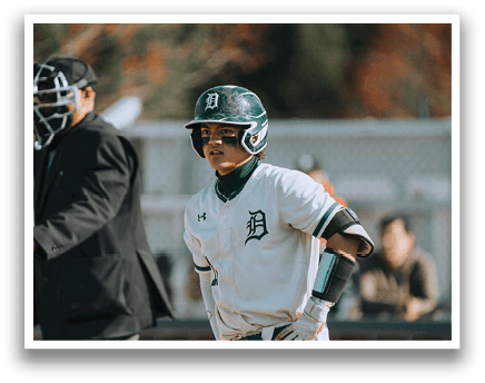 A baseball player wearing a green and white uniform. Description generated by AI