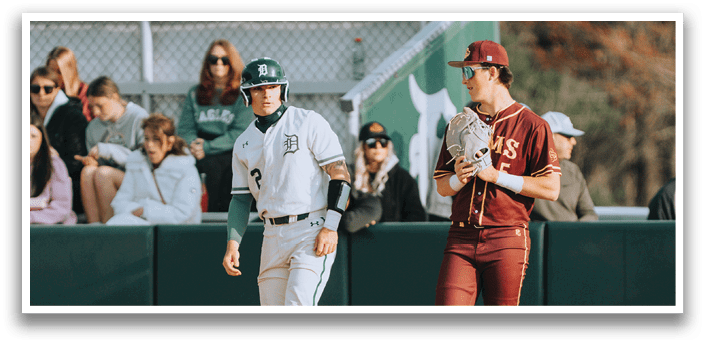 A baseball player wearing a white uniform stands on the field. Description generated by AI