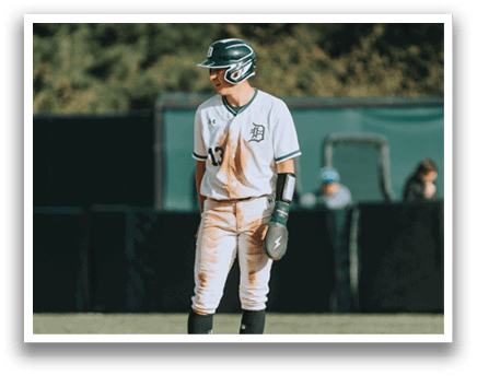 A baseball player wearing a green and white uniform. Description generated by AI