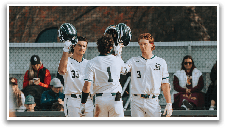 Three baseball players wearing white uniforms and green hats celebrating a win. Description generated by AI