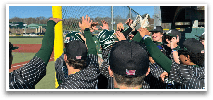 A group of baseball players standing on a field. Description generated by AI