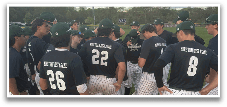 A group of baseball players wearing blue shirts and white pants. Description generated by AI