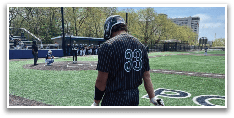 A baseball player holding a bat on a field. Description generated by AI