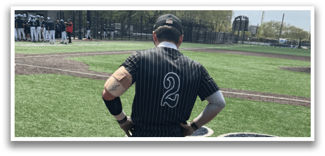 A baseball player holding a bat. Description generated by AI