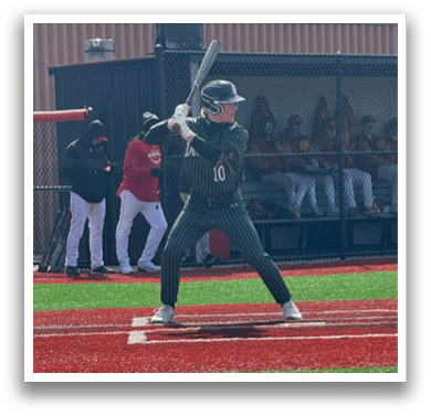 A baseball player is at bat, holding a bat and waiting for the pitch. Description generated by AI