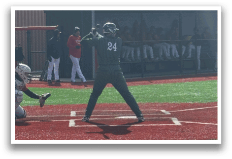 A baseball player is at bat, holding a bat and waiting for the pitch. Description generated by AI