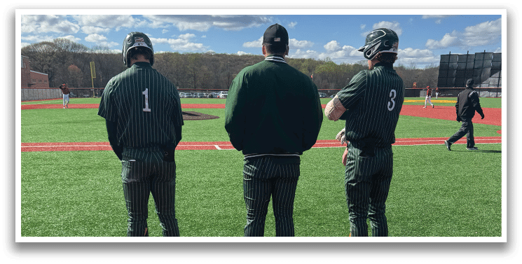 A baseball field with three men standing on it. Description generated by AI
