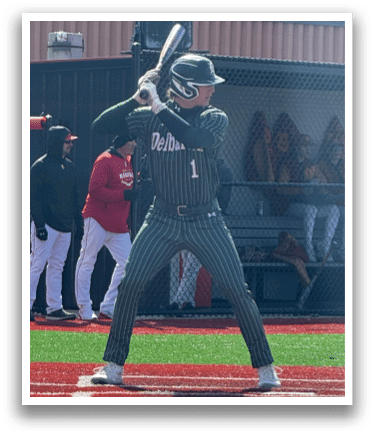 A baseball player in a green uniform is holding a bat and getting ready to hit a ball. Description generated by AI