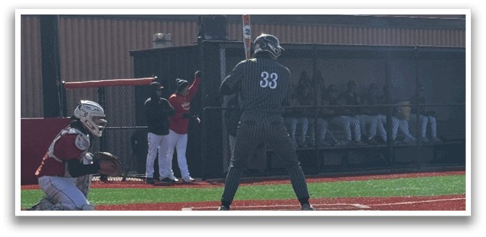 A baseball player is holding a bat and getting ready to hit a ball. Description generated by AI
