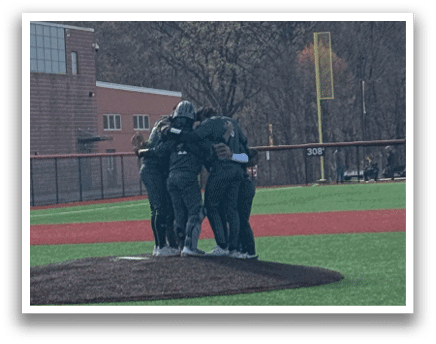 A group of people standing on a baseball field. Description generated by AI