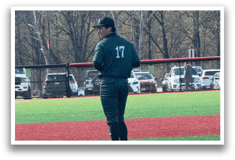 A baseball player is standing on the pitcher's mound. Description generated by AI
