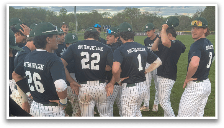 A group of baseball players wearing blue shirts and white pants. Description generated by AI