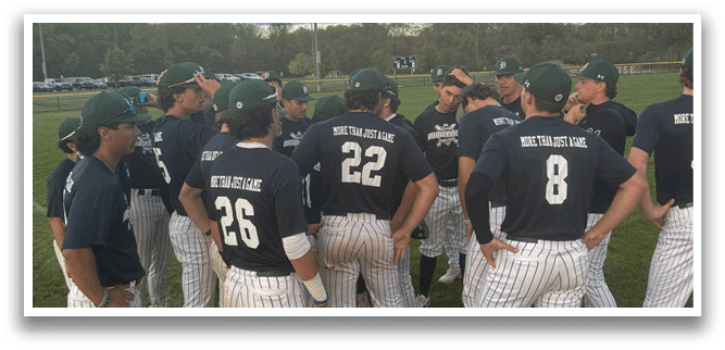 A group of baseball players wearing blue shirts and white pants. Description generated by AI