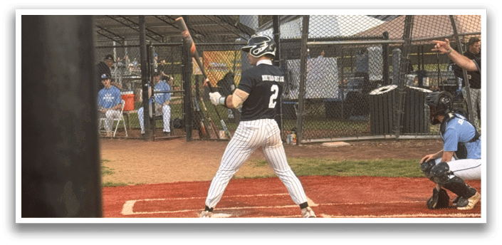 A baseball player is at bat, holding a bat and waiting for the pitch. Description generated by AI