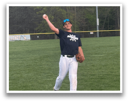 A man wearing a blue shirt and white pants is standing on a grassy field. Description generated by AI