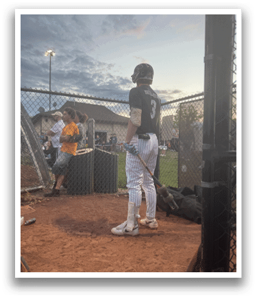 A baseball player is standing on the field. Description generated by AI