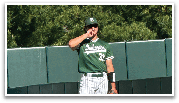 A baseball player standing on the field. Description generated by AI