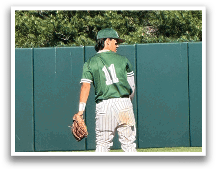 A baseball player wearing a green shirt and white pants is standing on a baseball field. Description generated by AI
