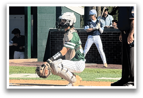A baseball player is crouching on the field. Description generated by AI