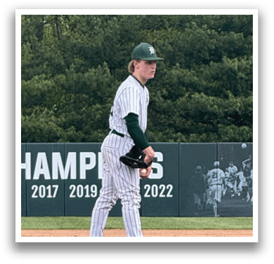 A baseball player is standing on the pitcher's mound. Description generated by AI
