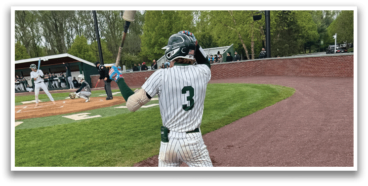 A baseball player is holding a bat and getting ready to swing. Description generated by AI