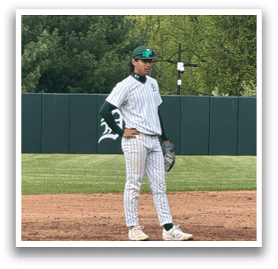 A baseball player standing on the field. Description generated by AI