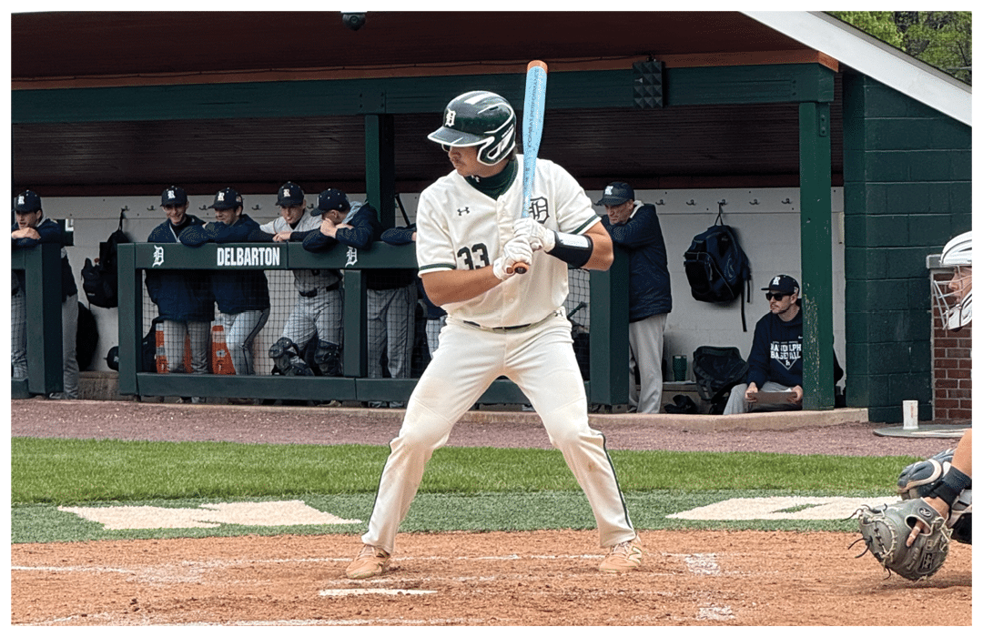 Baseball player holding a bat. Description generated by AI
