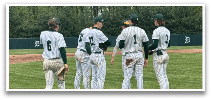 A group of baseball players standing on a field. Description generated by AI
