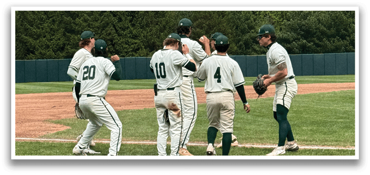 A group of baseball players huddled together on a field. Description generated by AI