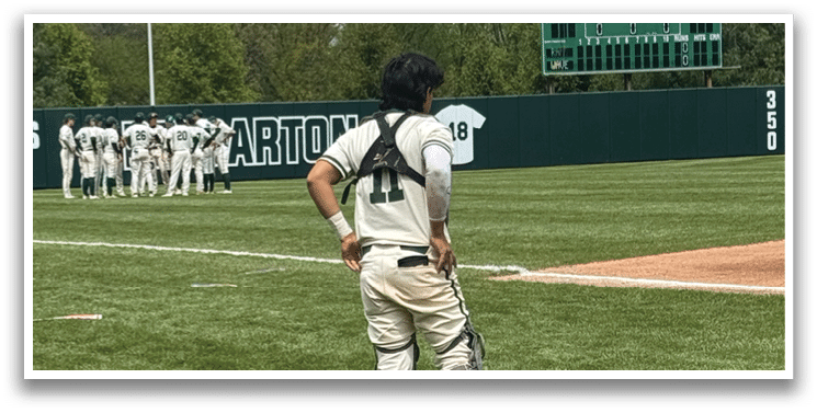 A baseball player standing on the field. Description generated by AI