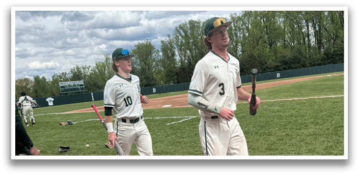 Two baseball players walking on a field. Description generated by AI