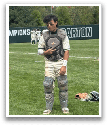 A baseball player standing on a field. Description generated by AI
