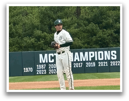 A baseball player standing on the pitcher's mound. Description generated by AI