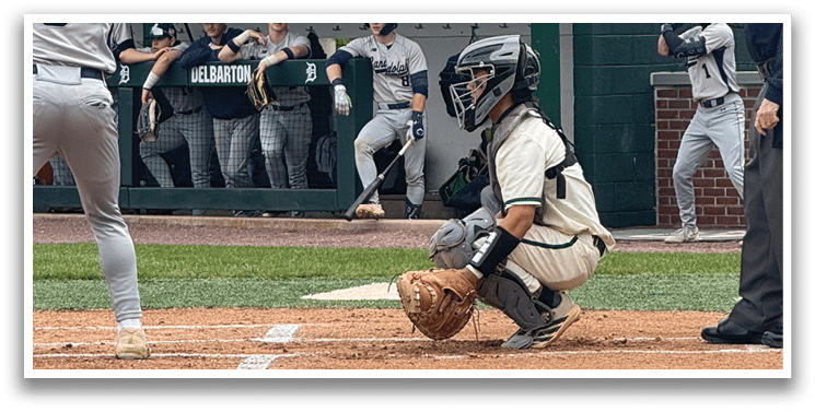 A baseball player is holding a bat and getting ready to hit the ball. Description generated by AI