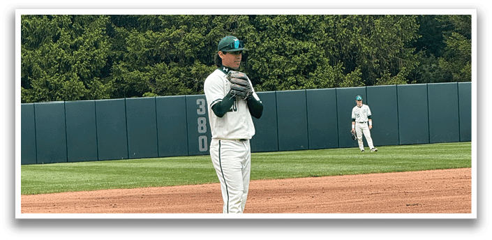 A baseball player is standing on the pitcher's mound. Description generated by AI