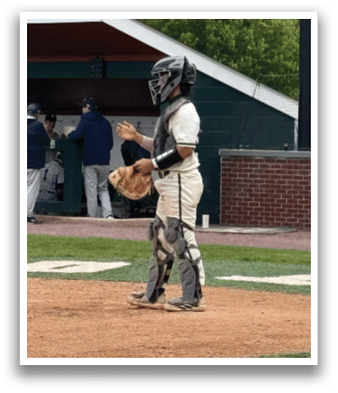 A baseball player is standing on the field. Description generated by AI