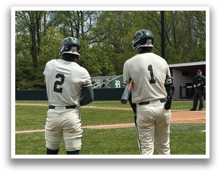 Two baseball players standing on the field. Description generated by AI