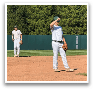 A baseball player is standing on the field. Description generated by AI