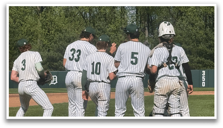 A group of baseball players standing on a field. Description generated by AI