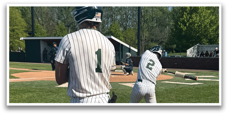 A baseball player is swinging a bat on a field. Description generated by AI