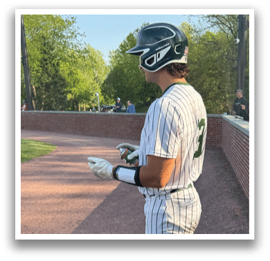 A baseball player holding a bat. Description generated by AI