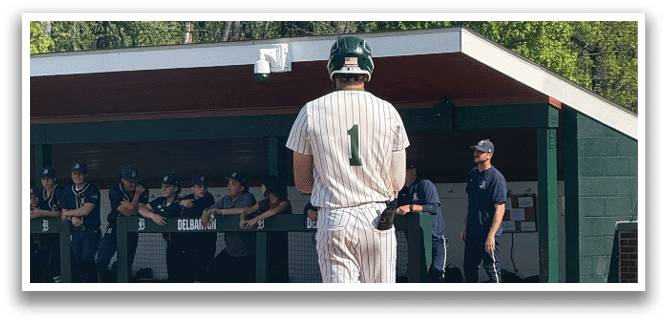 A baseball player is standing on the field. Description generated by AI